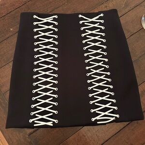 Mikhael Kale black mini skirt with white lace-up detail